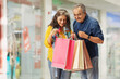 © IndiaPix - A HUSBAND AND WIFE HAPPILY CHECKING AT SHOPPING BAGS TOGETHER
