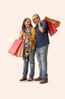 © IndiaPix - A HAPPY COUPLE USING MOBILE PHONE WHILE STANDING WITH SHOPPING BAGS