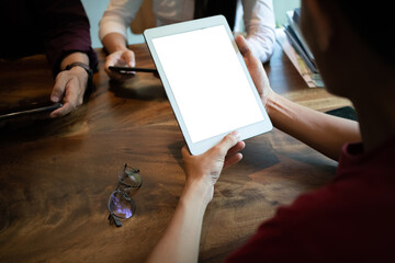 newsletter concept Hand of a young man checking email message box on digital tablet mock-up device. working at the coffee shop