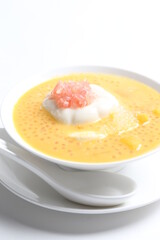 chilled mango sago fruit with pomelo and soya pudding jelly in white bowl sweet dessert menu