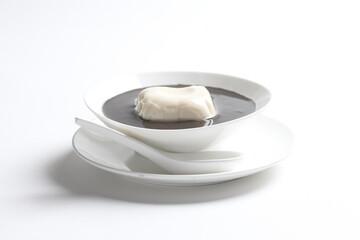 chef cook thick black sesame sweet soup with soya milk pudding jelly in white bowl Chinese traditional dessert menu