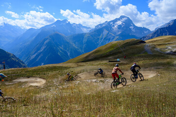 Extreem outdoor sport challenge in French Alps mountains in summer, riding downhill on sport bike on special bicycle path