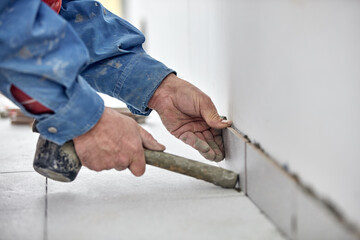 Wall Mural - Ceramics tile man worker placing new tiles on the floor and wall.