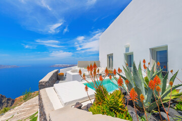 Wall Mural - Greece Santorini island in Cyclades, traditional sights of colorful and white washed houses with wooden frames and flowers