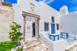Fototapeta Uliczki - Greece Santorini island in Cyclades, traditional view of white washed houses with colorful wooden frames