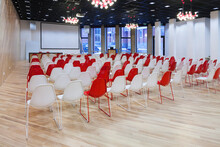 Large Empty Room With Red And White Chairs In Rows