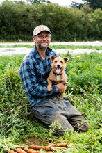 Farmer In A Field With His Dog