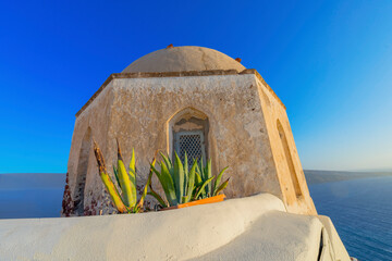 Wall Mural - Stunning cupolas with the Caldera (volcano) in the distance in the Greek island of Santorini