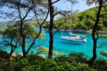 Wall Mural - sailboat anchored at Cape Amarandos near Aghnondas in greek Skopelos Island