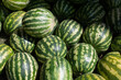 © Hulya Koca/Wirestock - Pile of fresh watermelons for sale at a market
