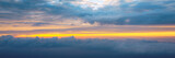 Fototapeta Na ścianę - Beautiful sunset sky above clouds with dramatic light. Cabin view from airplane. Flying above the clouds. view from the airplane. Beautiful blue sky background with sunset. Sunset above the clouds.