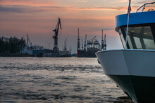 Ship Moored At Harbor Against Sky During Sunset