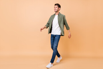 Poster - Full body photo of charming happy young woman look empty space wear casual clothes isolated on beige color background