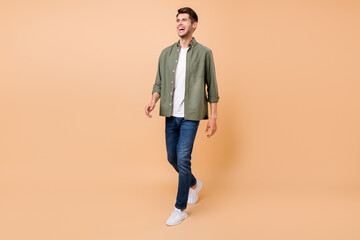 Aufkleber - Photo of funny handsome young gentleman wear khaki shirt walking laughing smiling isolated beige color background