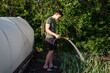© vitec40 - guy watering a hose in the garden
