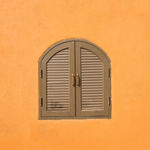 Close-up Of Window On Orange Wall