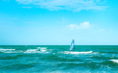 Windsurfing in the sea. Windsurfing - is a surface water sport that combines sailing and surfing.