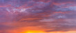 © Maarten Zeehandelaar - Sunset panorama of cloud blanket texture and detail brightly colorful lit up orange from below with blue tints in the background. Painterly vibrant weather condition wallpaper backdrop.