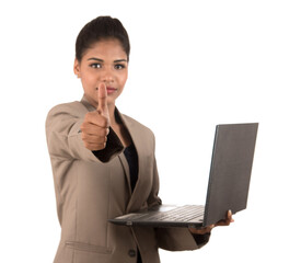 Happy excited business woman holding laptop and showing thumbs up isolated on a white background