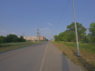 Wall Mural - electric power lines over green landscape and road