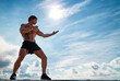 © ZaStock - A muay thai or kickboxer training with shadow boxing outdoor