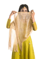 Portrait of beautiful traditional Indian girl posing on white background.