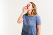 © AntonioDiaz - Sick woman blowing her nose with blood