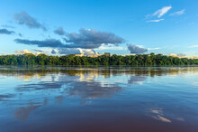 Amazon River Landscape With Sunset Cloud Reflection, Iquitos, Peru. The Tributaries Of The River Flow Through (French) Guyana, Venezuela, Colombia, Ecuador, Peru, Bolivia, Suriname, Brazil.
