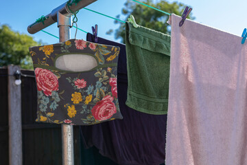 Peg bag hanging on an outdoor clothes line