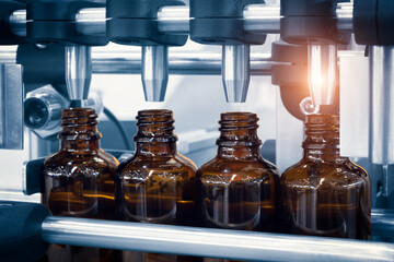 Poster - pharmaceutical industry, medicine pills are filling in the  glass bottle on production line machine conveyor at the medical factory. selective focus.