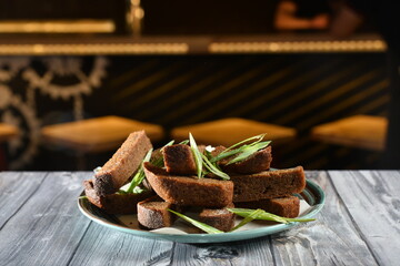 beer snack roasted crispy bread. toasts served in the bar on wooden table