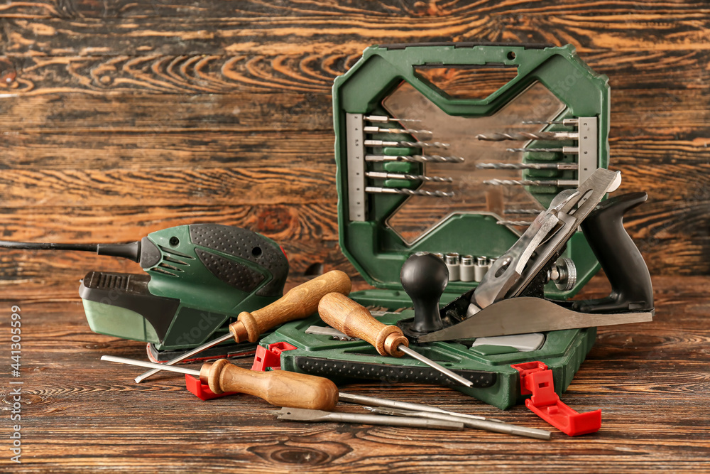 Set of carpenter's tools on wooden background