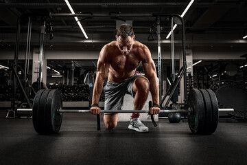 Athlete, man doing deadlift with a barbell young athlete preparing for a heavy weight barbell lifting workout