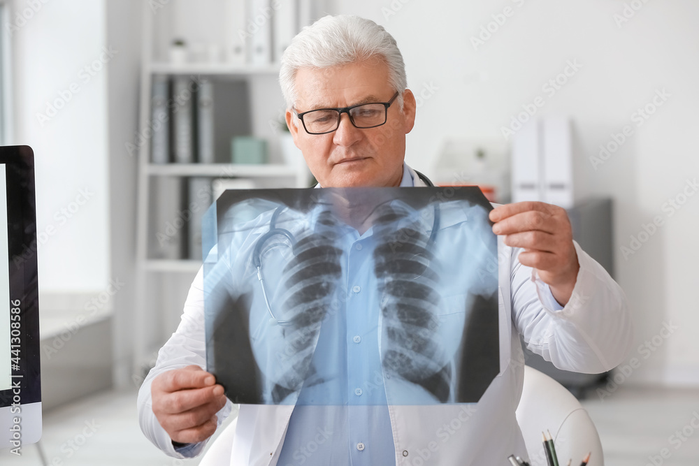 Pulmonologist with x-ray image of lungs in clinic