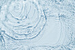© Alex Shi - Water spills on a light blue background. Natural sunlight and shade. Beautiful burst. Summer mood. Minimal style.