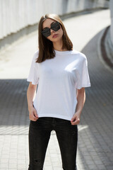 Girl or woman wearing white blank t-shirt with space for your logo, mock up or design in casual urban style