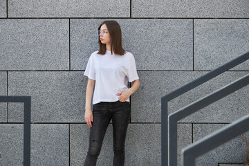 Wall Mural - Girl or woman wearing white blank t-shirt with space for your logo, mock up or design in casual urban style