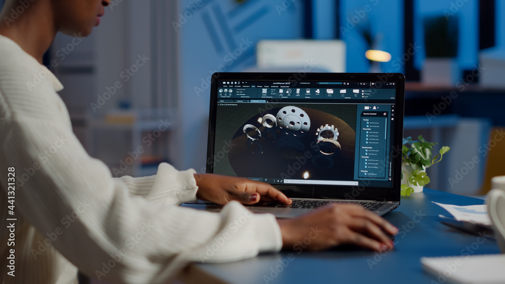 Tired african designer engineer analyzing new prototype of 3D model of ...