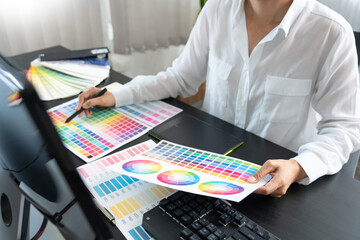 Poster - creative graphic designer choosing color scale for editing artwork while working in office.