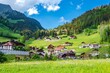 Houses, alps mountain, green fields  in Jaun, Canton Fribourg, Freiburg nearby Bulle, Bern, Thun. Good hiking tourist way. Switzerland.