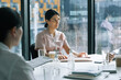 © Seventyfour - Portrait of female doctor sitting at meeting table in conference room at medical seminar, copy space