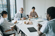 © Seventyfour - High angle view at diverse group of doctors sitting at meeting table in conference room during medical seminar, copy space