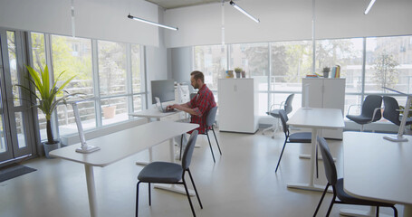 Young man working alone in empty office