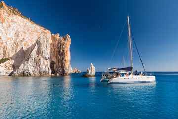 Wall Mural - Boats at anchor in the turquoise sea of the south coast of the uninhabited island of Poliegos near Milos in the Greek Cyclades