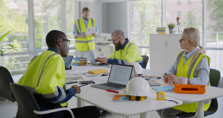 Wall Mural - Diverse engineers inspecting in workplace architectural plan