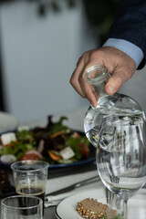 person holding a glass of water