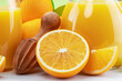 Yellow orange fruits and carafe of fresh orange juice isolated close up.