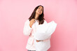 © luismolinero - Young woman in pajamas isolated on pink background with tired and sick expression