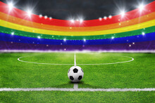 Ball on the green field in soccer stadium. ready for game in the midfield with lgbt colors