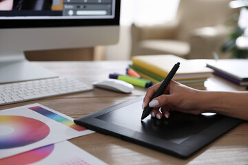 Poster - Professional retoucher working on graphic tablet at table, closeup